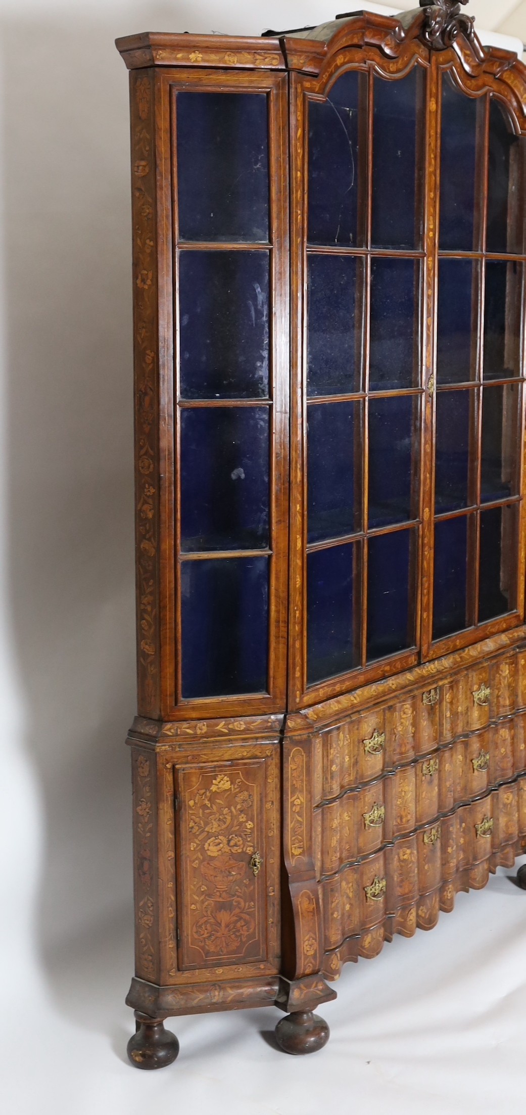 A late 18th century Dutch marquetry inlaid walnut serpentine display cabinet, width 186cm depth 36cm height 260cm